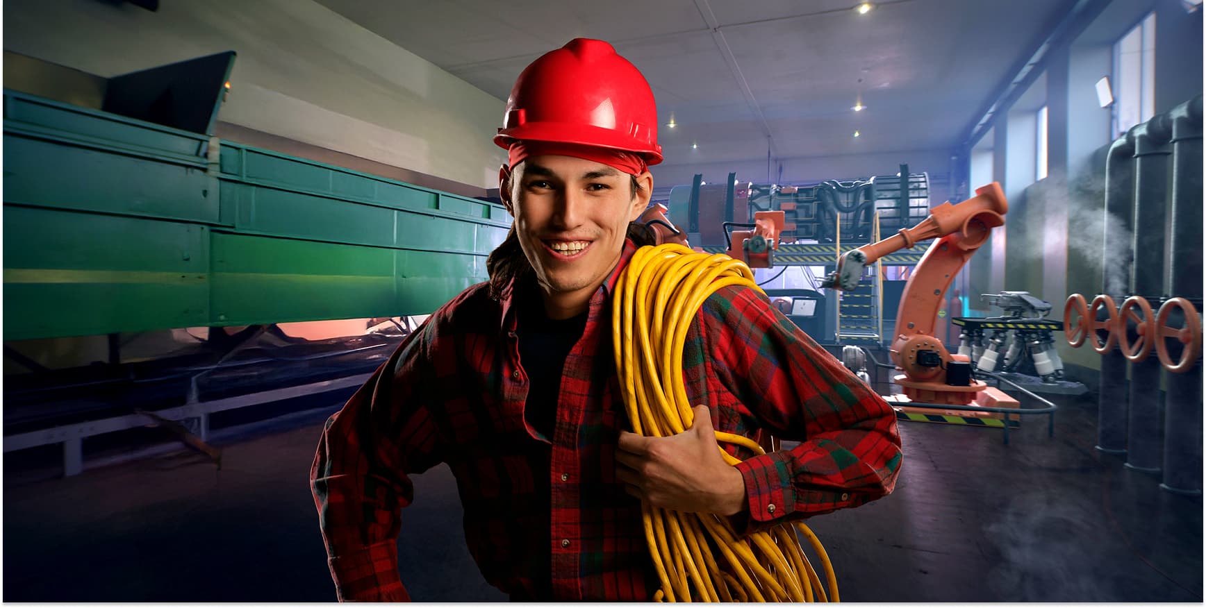 Man smiling and working in an industrial space.