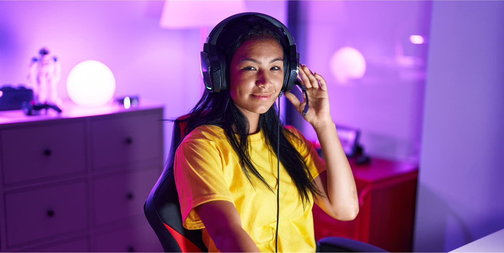 Indigenous woman in her home office, wearing a headset.